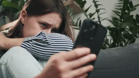 Worried daughter looking at phone