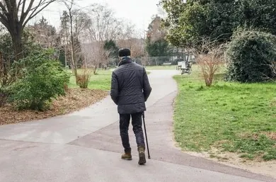 Elderly man walking alone