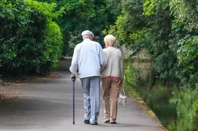 Senior couple walking peacefully in park